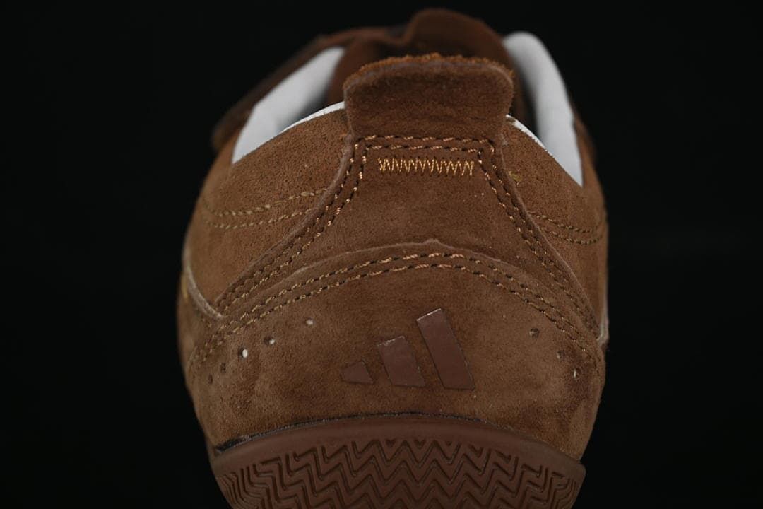 Rear view of the brown sneaker with heel logo and patterned sole
