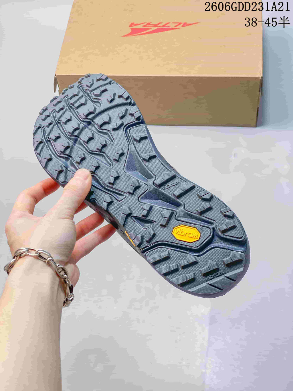 Close-up of the trail shoe outsole with pronounced lugs and Vibram branding