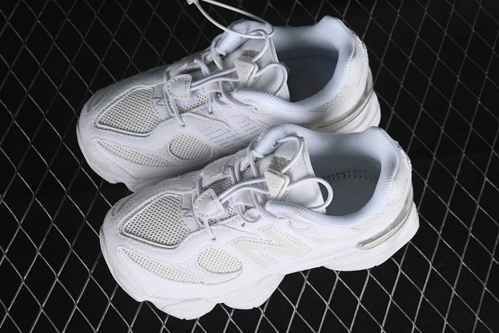 Pair of white sneakers shown from above at an angle.