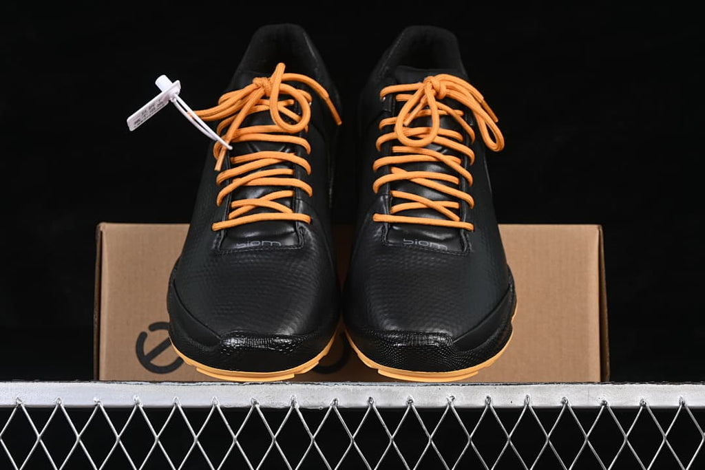 Front view of the pair showing black uppers and orange laces