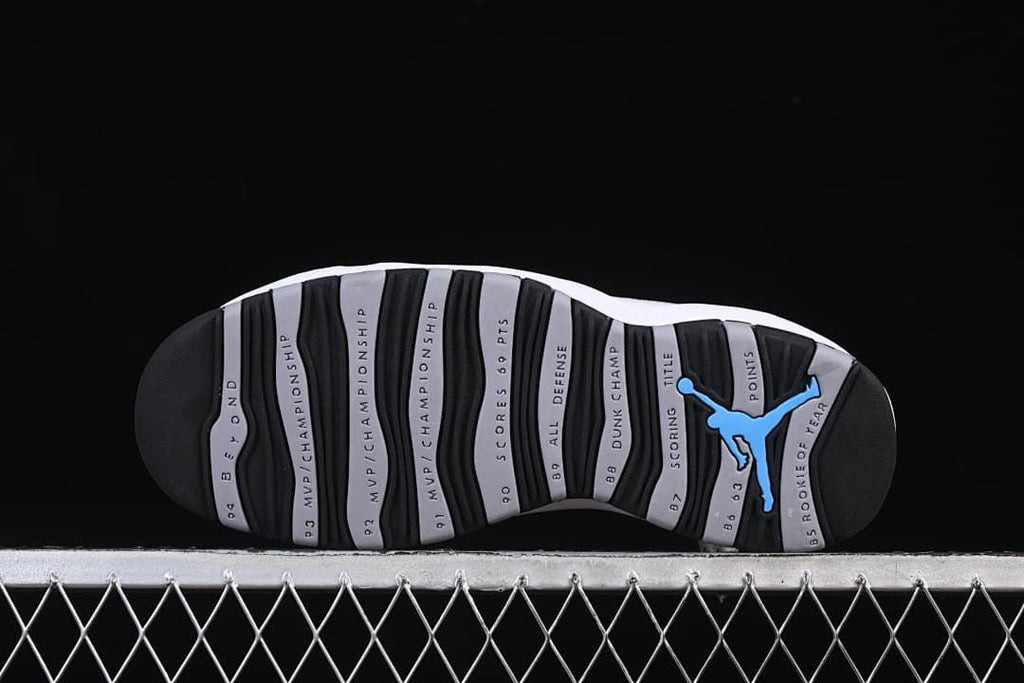 Outsole with black and grey sections, milestone text, and a blue Jumpman detail