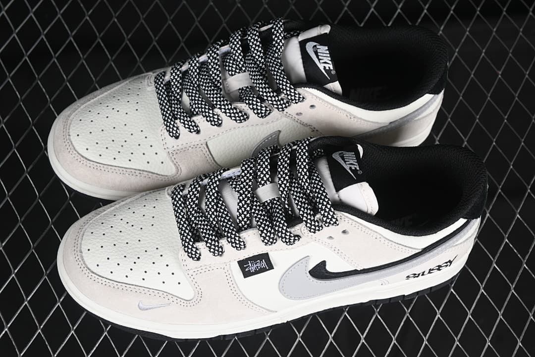 Pair of white and grey low-top sneakers with black-and-white patterned laces