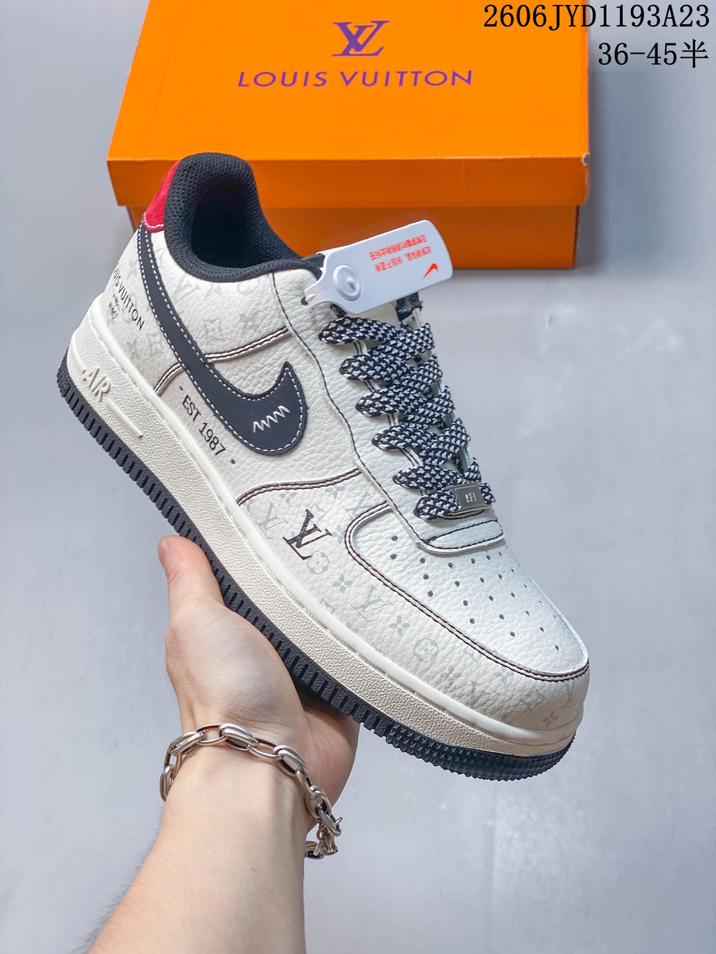 Side view of a cream low-top sneaker with dark accents, patterned panels, patterned laces, and a perforated toe.