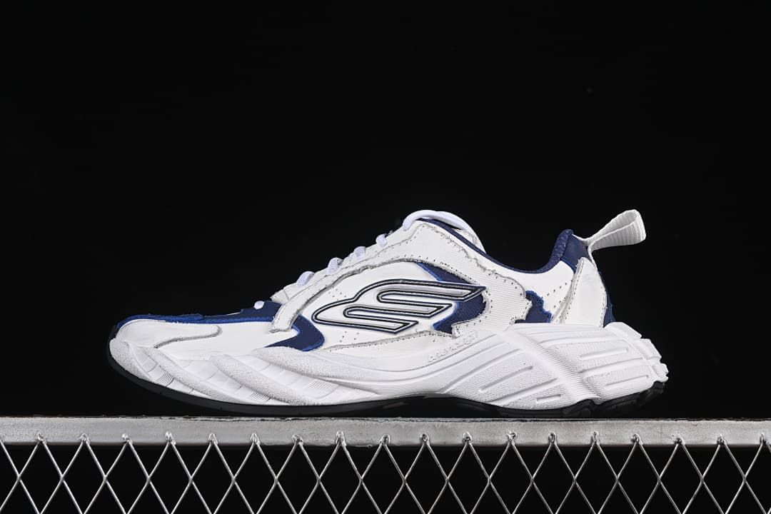 Side view of the white and navy sneakers against a dark background.