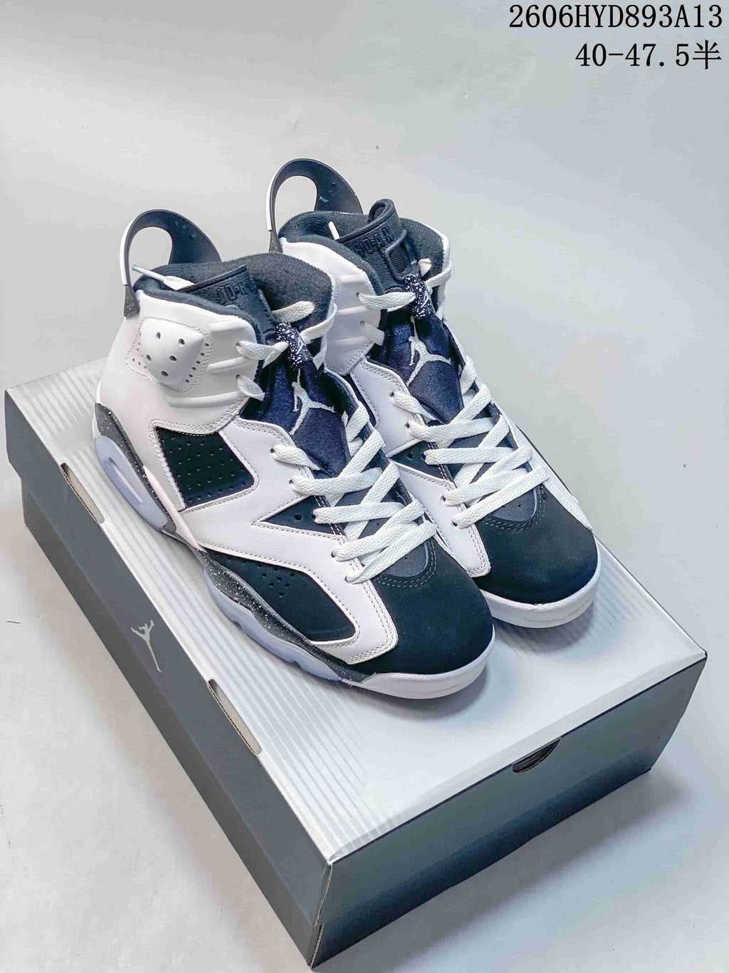 Pair of white and dark Jordan Air Jordan 6 Retro Oreo high-top sneakers on a shoebox
