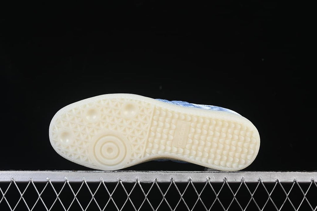 Underside view of the cream-colored patterned outsole