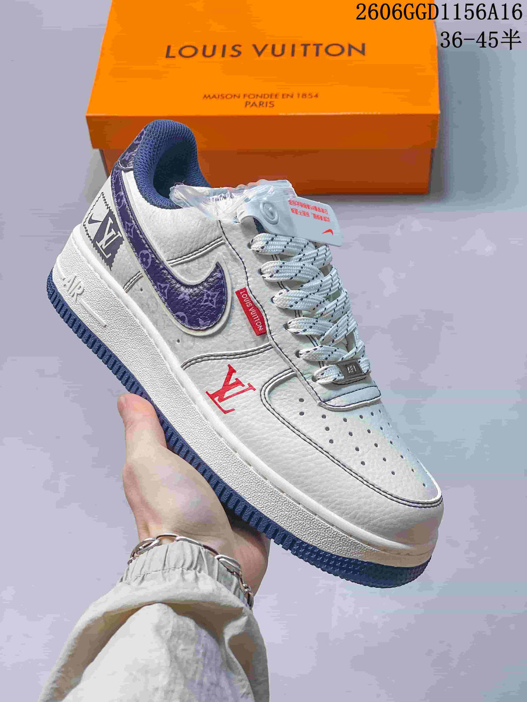 Angled view of the sneaker with off-white upper, navy accents, and red logo details