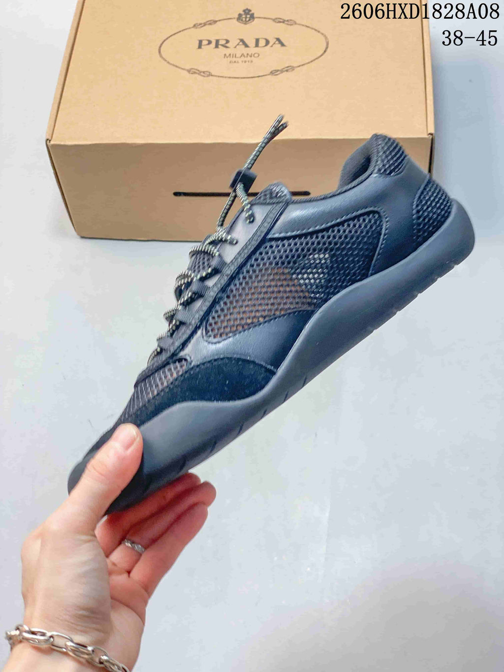 Side view of a dark blue mesh sneaker with contrasting overlays and a chunky sole.