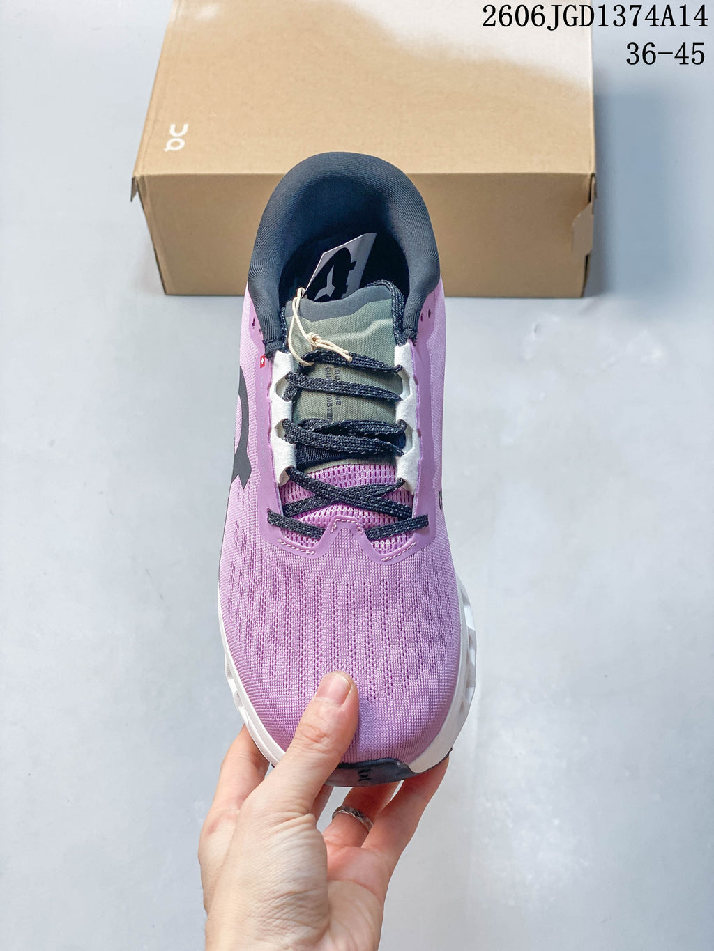 Top view of the lilac running shoe showing its laces, tongue, and padded collar.