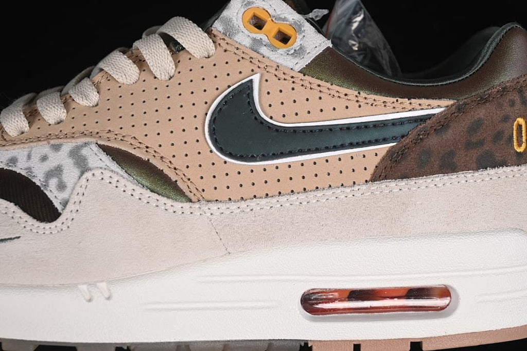 Close-up of perforated tan panels, dark Swoosh, patterned overlay, and heel Air unit
