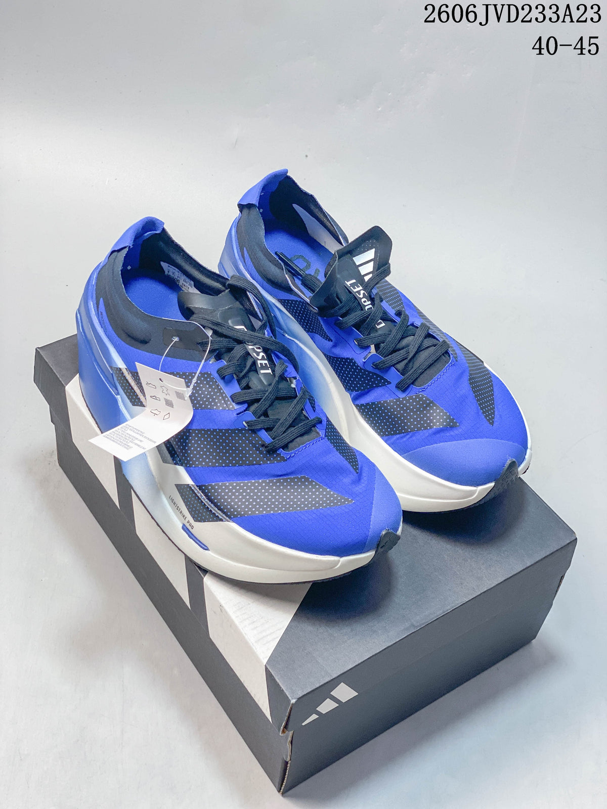 Blue Adidas Adizero Prime X3 running shoes displayed on a shoebox