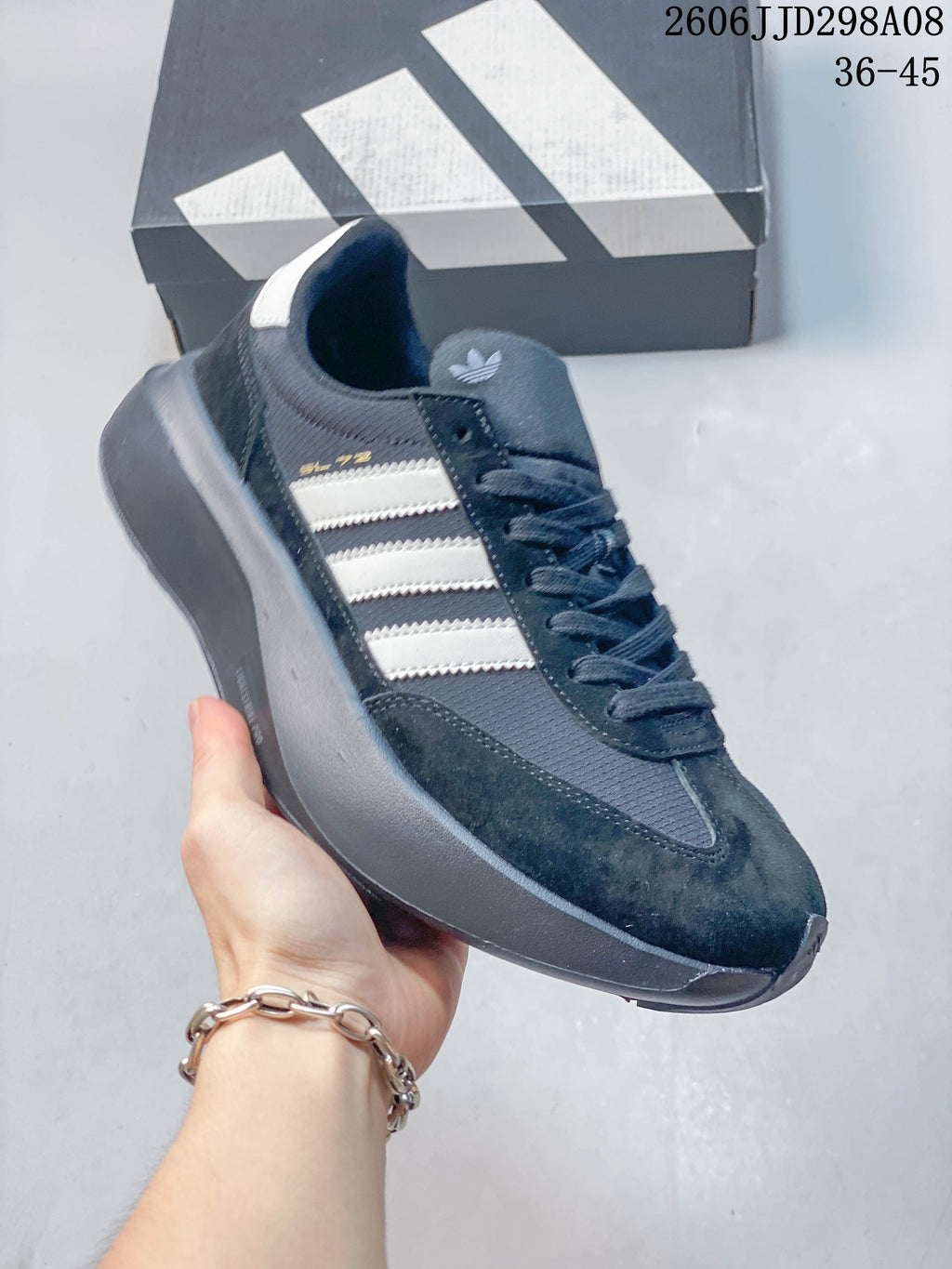 Angled view of a dark navy adidas SL 72 Pro sneaker with white stripes