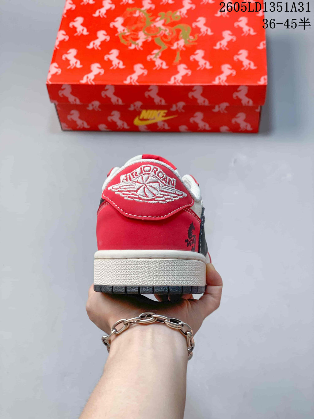 Rear view showing the red heel panel and embroidered winged logo