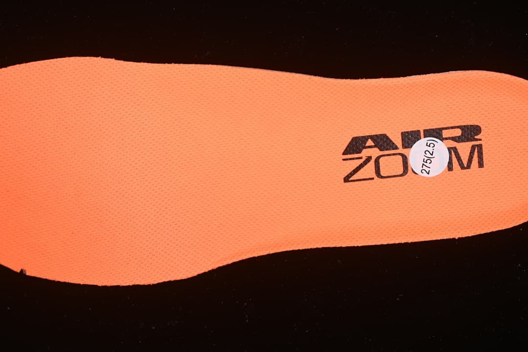 Orange insole marked Air Zoom with a size sticker