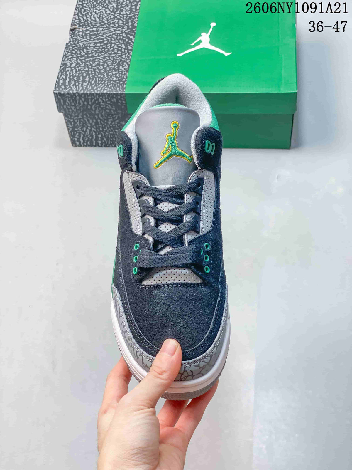 Front view of the sneaker showing dark laces, green eyelet accents, and patterned toe overlay