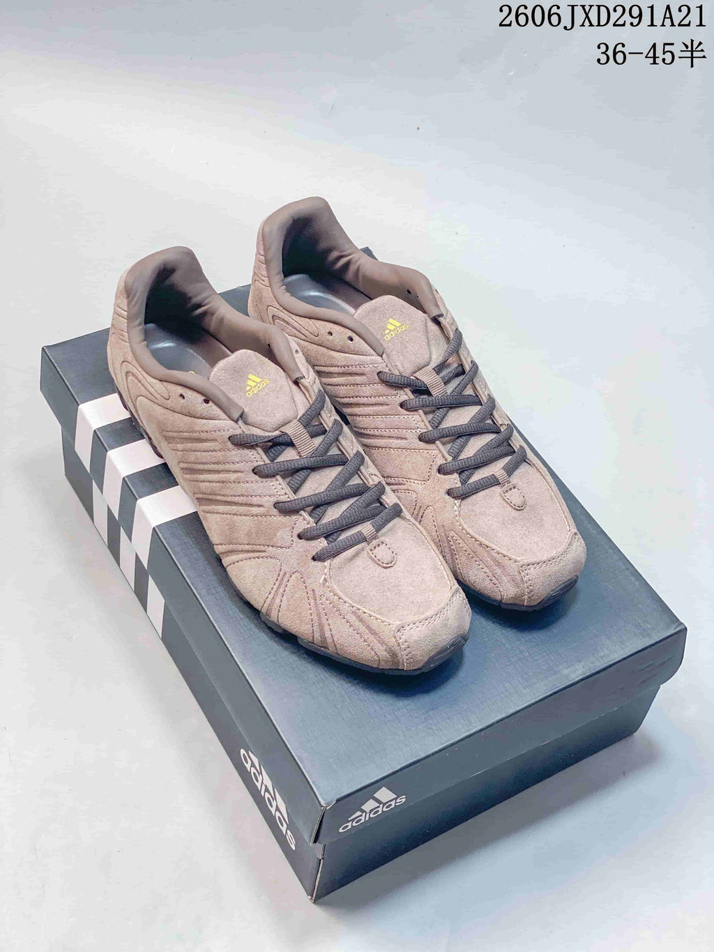 Pair of taupe Adidas Originals Ghost Sprint sneakers on a shoe box