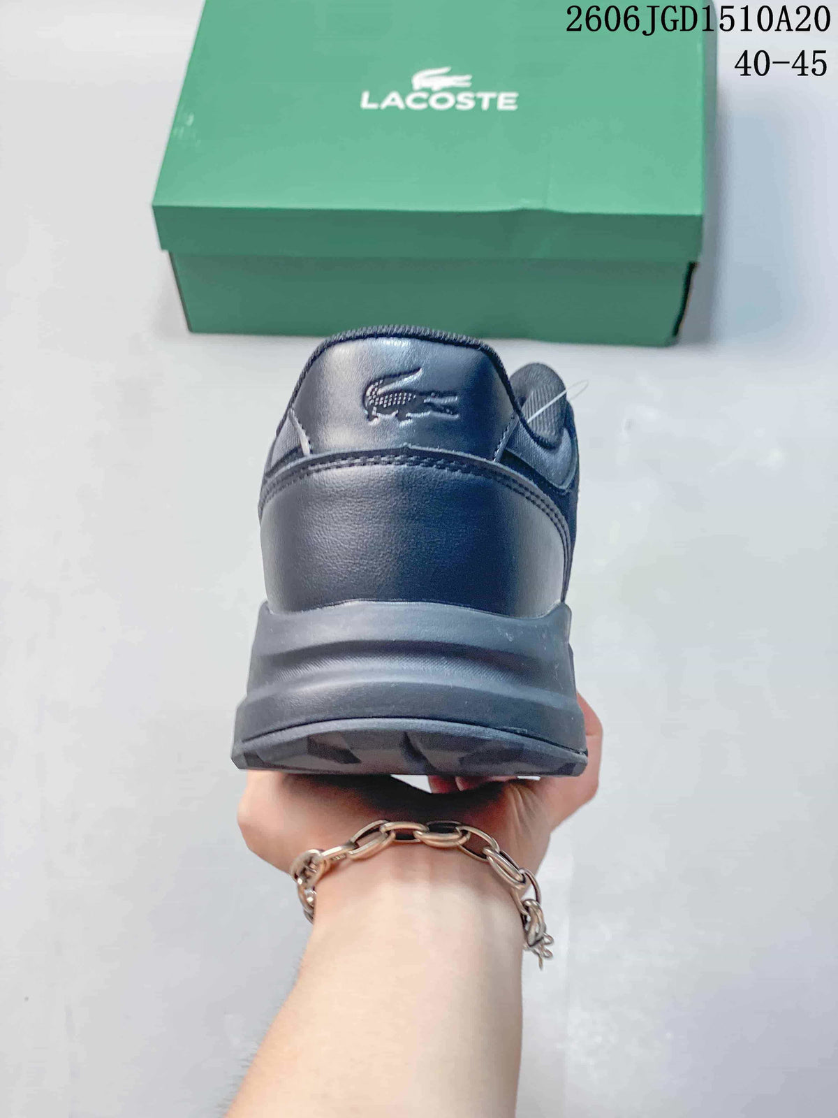 Rear view of a dark navy Lacoste sneaker showing its heel and thick outsole.