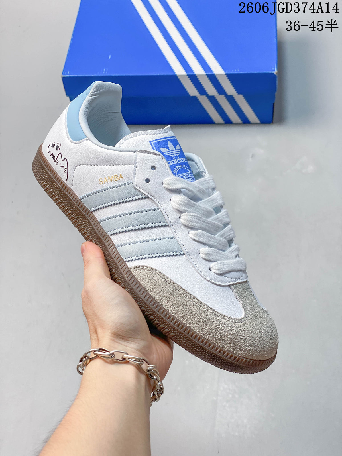 White low-top sneaker with pale blue stripes and heel accent, plus a gum sole.