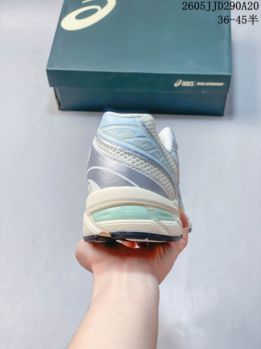 Rear view of the silver and pale blue ASICS GEL-1130 sneaker