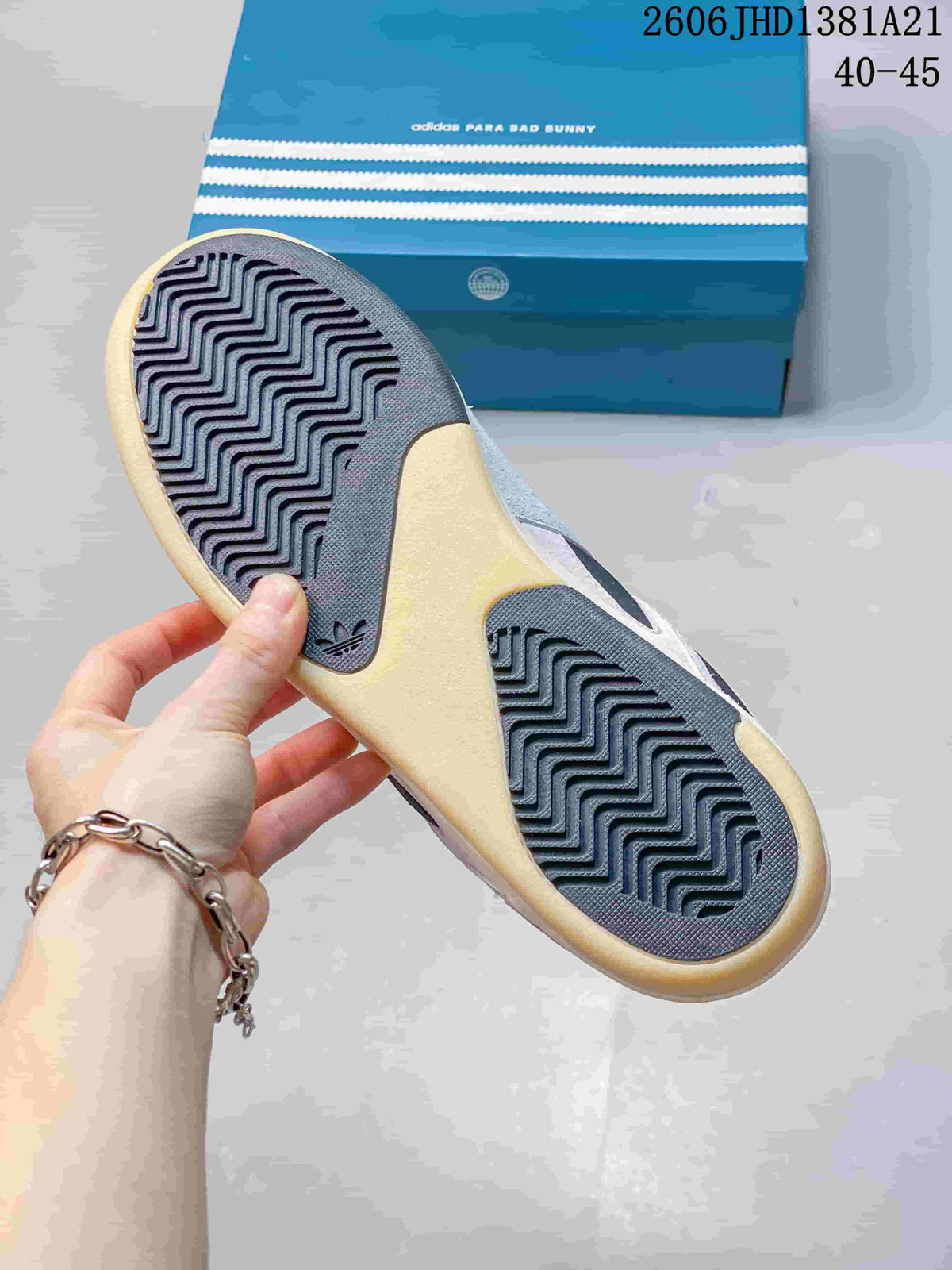 Close-up of the sneaker outsole with patterned tread and blue adidas-branded box