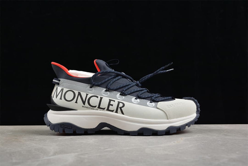 Side view of the sneaker with large Moncler lettering and contrast accents.