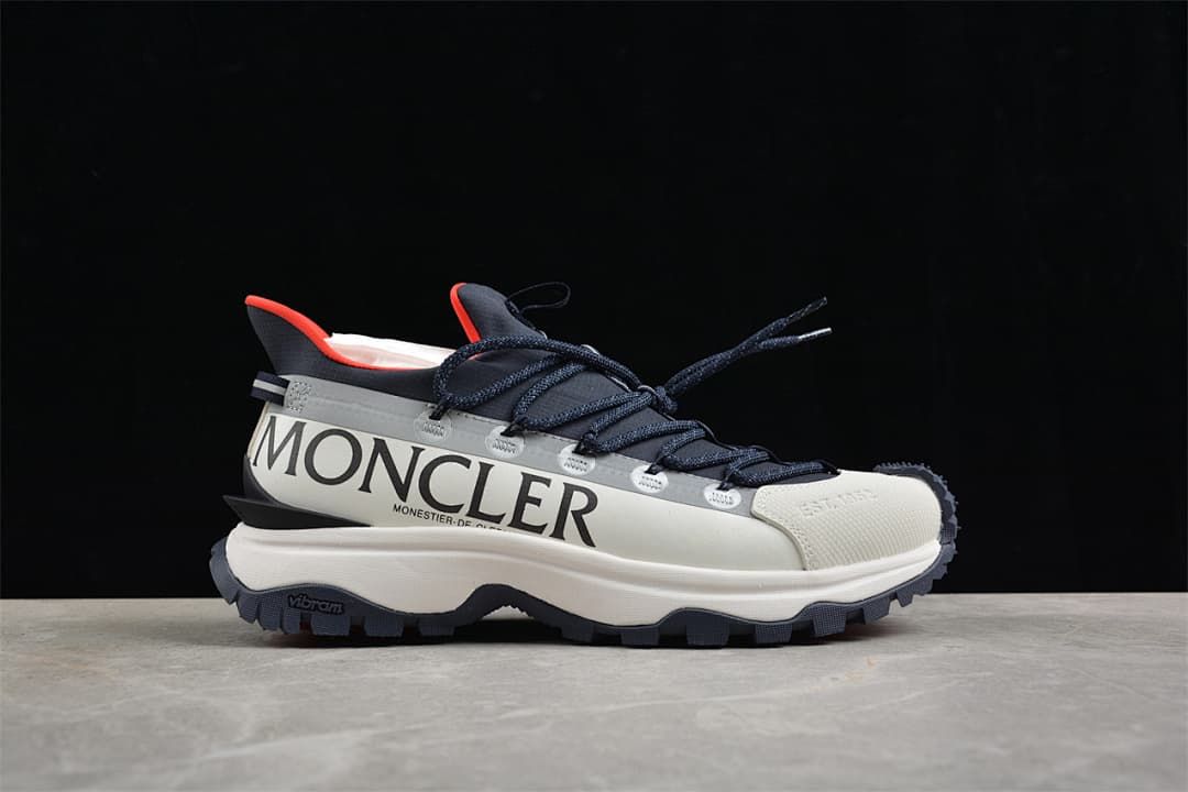 Side view of the sneaker with large Moncler lettering and contrast accents.