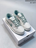 Pair of white and sage Nike Dunk Low Retro sneakers viewed from above on a shoebox.