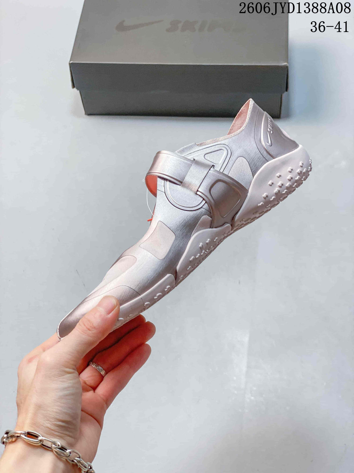 Side view showing the strap and split-toe design of a Nike Air Rift shoe