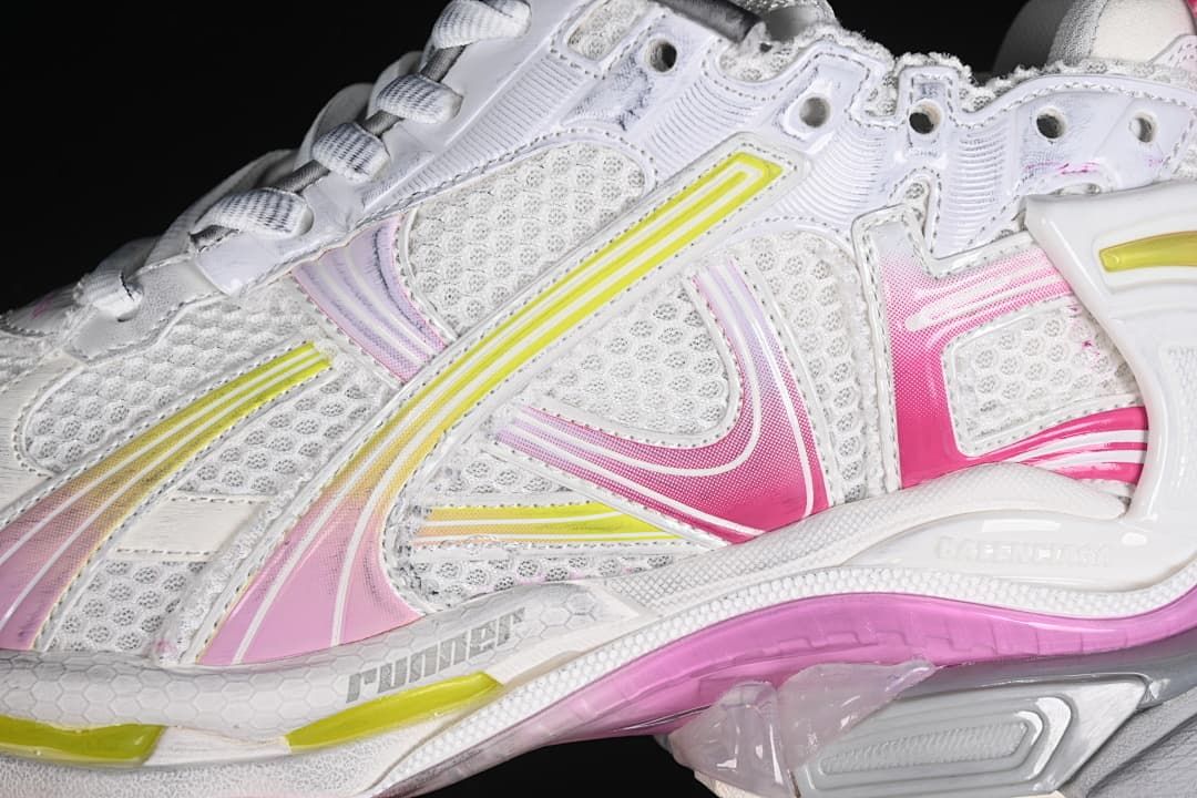 Close-up of mesh panels and layered pink and yellow side accents.