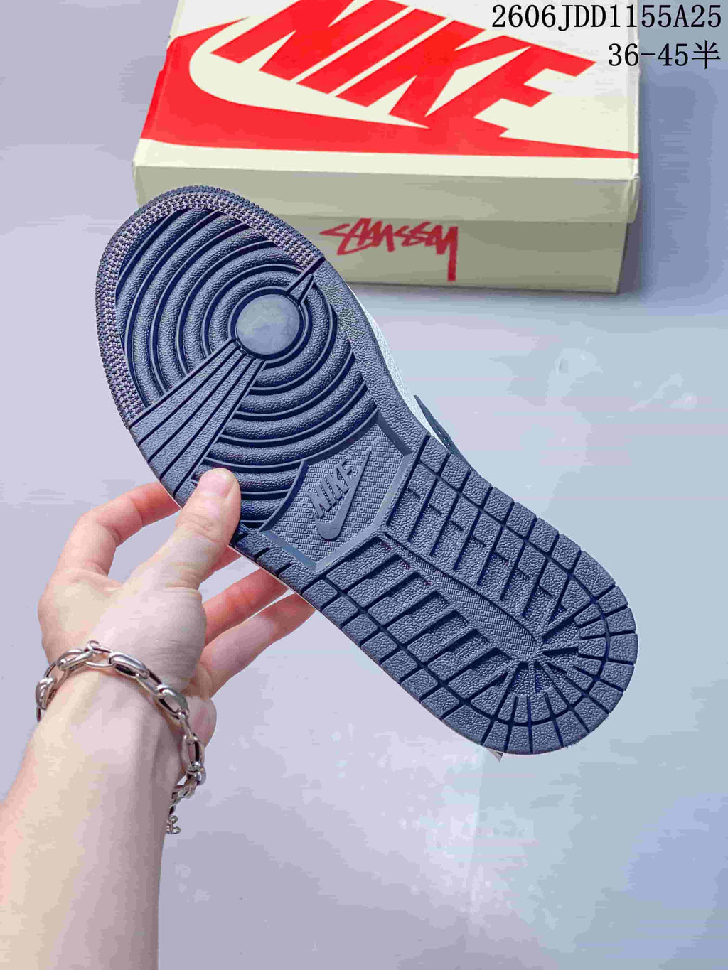 Close-up of the navy patterned outsole on the low-top sneaker
