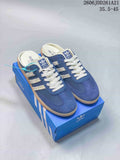 Blue and cream adidas Samba Mule shoes shown from above on a blue box
