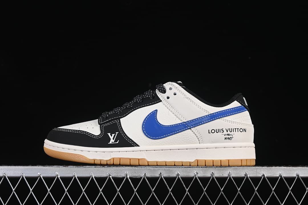 Side view of a white, black, and blue low-top sneaker with contrast stitching and a gum-colored outsole.
