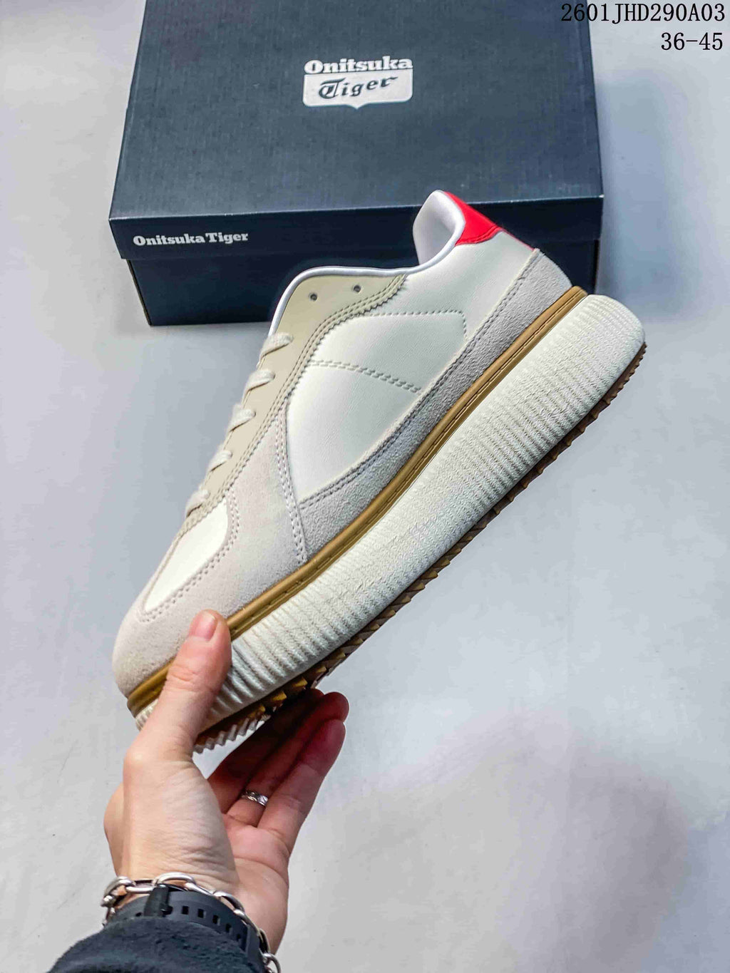 Side view of the cream and beige low-top sneaker with red heel accent and ribbed sole
