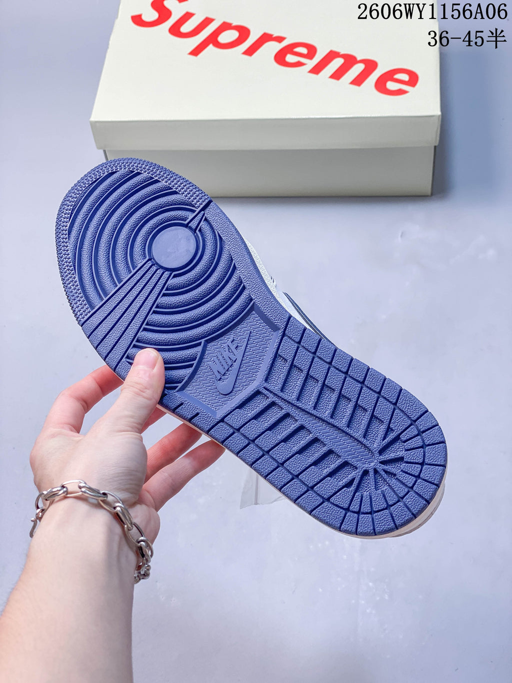 Blue outsole shown on the white and blue low-top sneaker