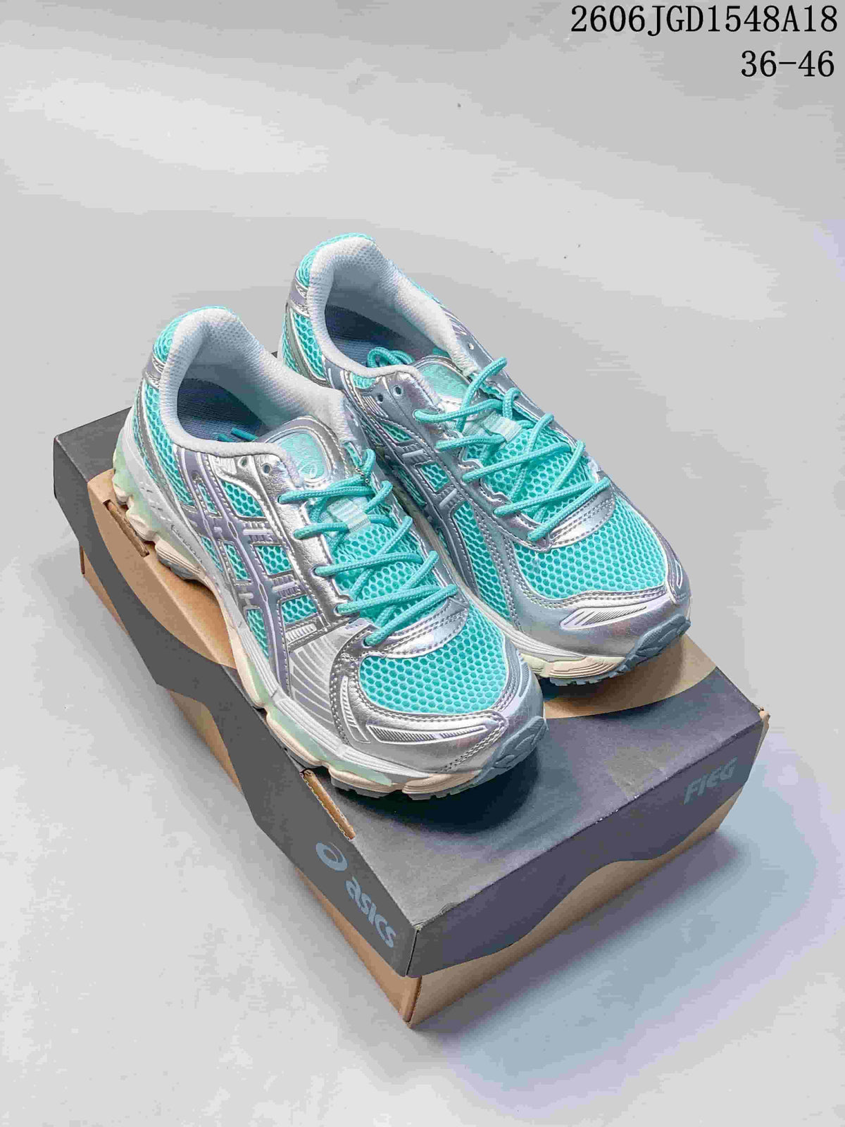 Pair of silver and turquoise ASICS GEL-KAYANO 12.1 running shoes shown from above.