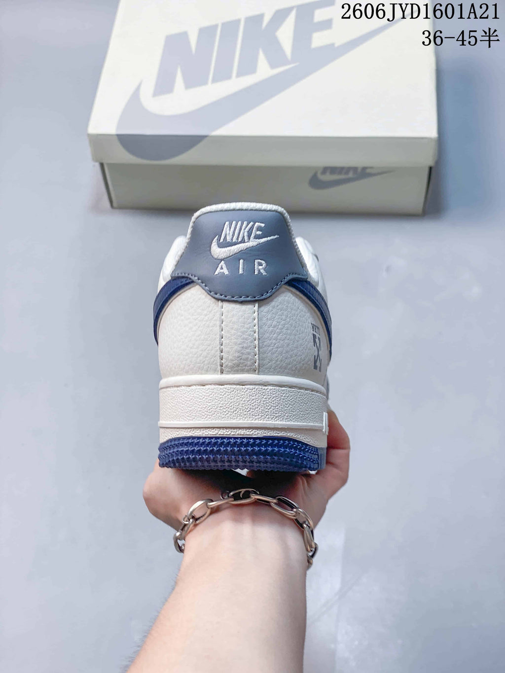 Rear view of the white sneaker with blue heel details