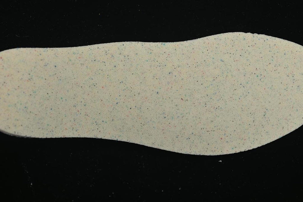 Speckled light-colored shoe insert shown from above