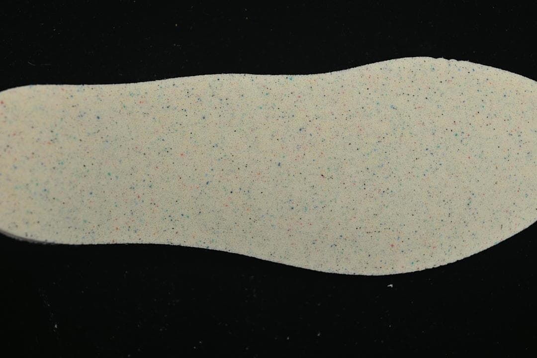 Speckled light-colored shoe insert shown from above