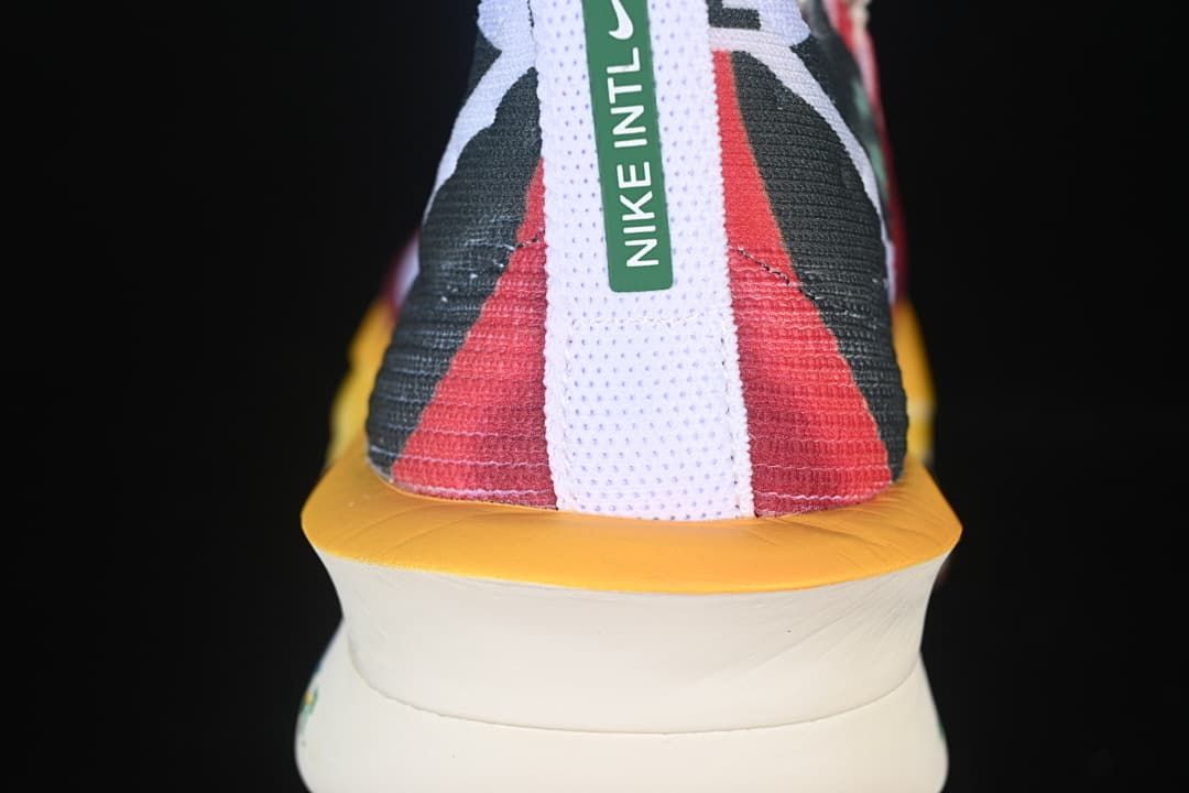 Rear view of the shoe with contrasting heel panels and yellow sole edge