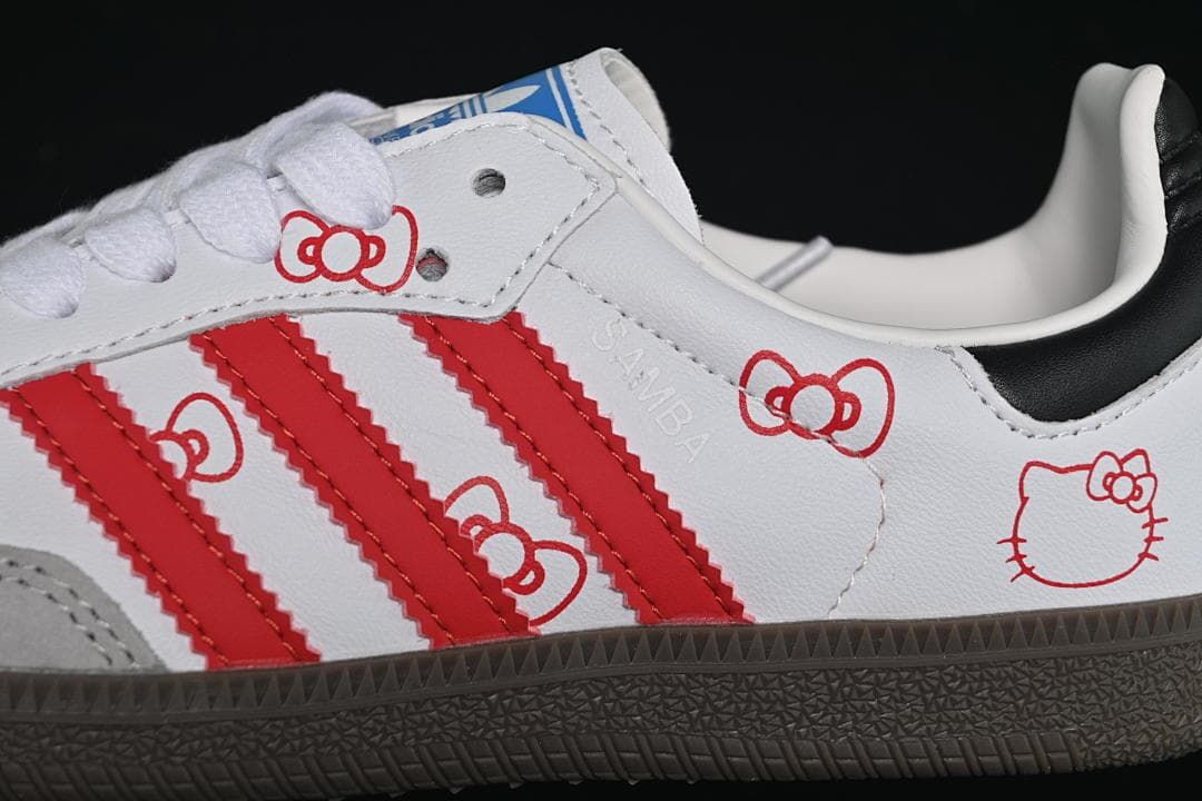 Close-up of red stripes and Hello Kitty graphics on the sneaker upper