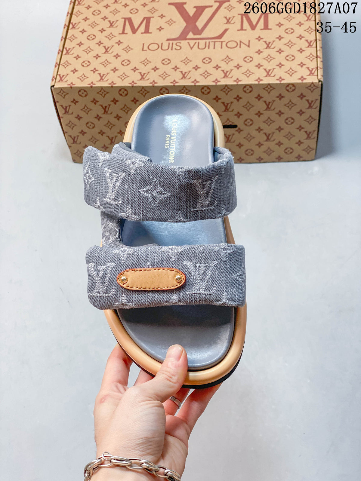 Top view of the gray slide sandal showing two patterned straps and tan-colored strap detail.