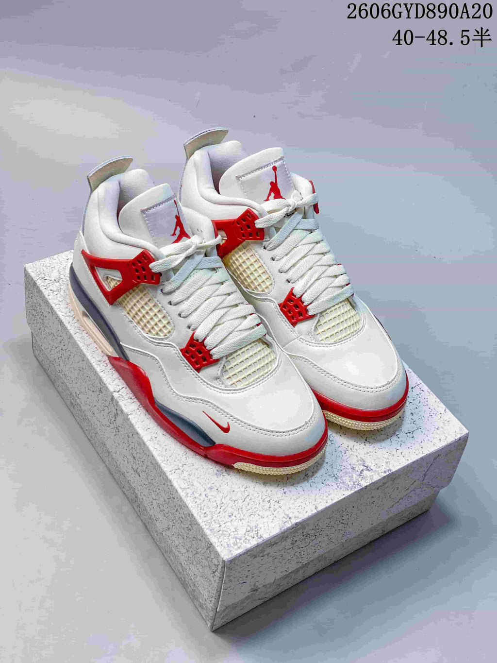 Pair of white and red Air Jordan 4 Retro sneakers shown from above