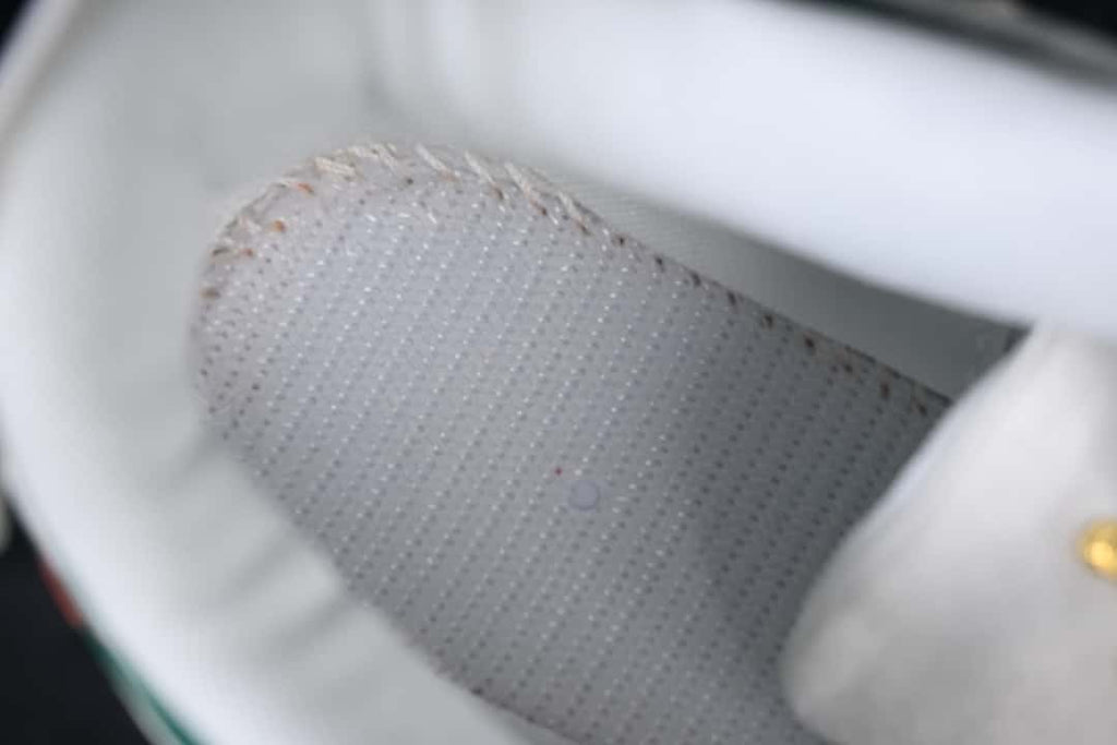 Close-up view inside the sneaker showing a perforated lining