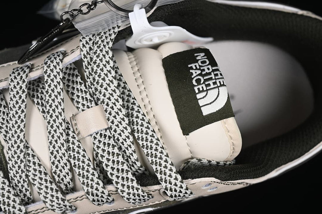Close-up of patterned laces, tongue label, and attached accessories