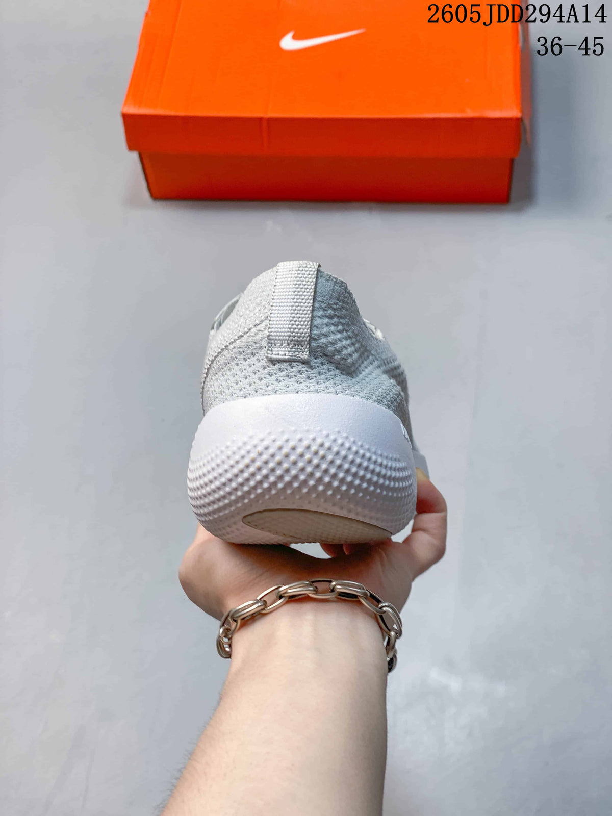 Rear view showing the knit-look heel and textured sole of a light gray Nike Free shoe