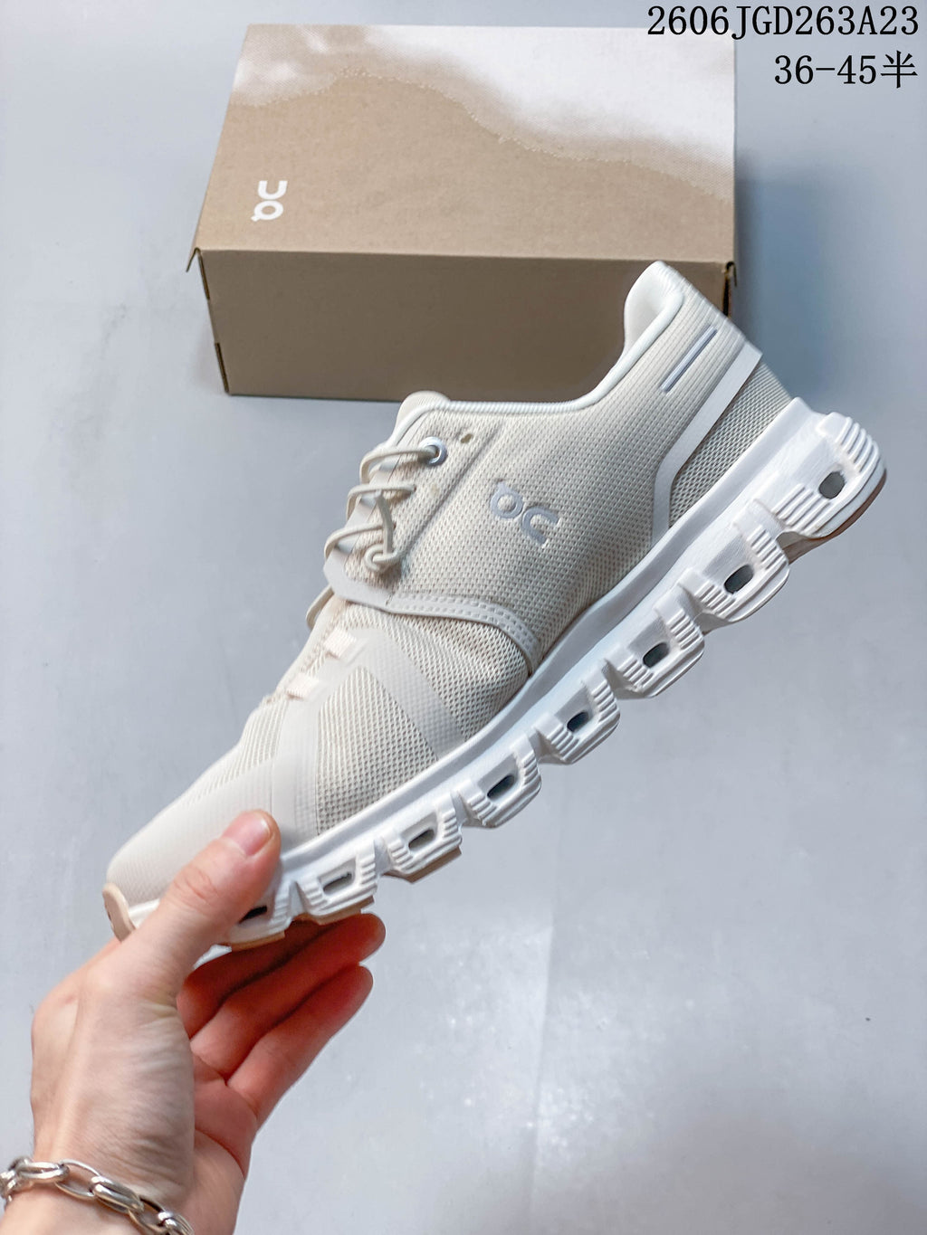 Side profile of a light ivory On Cloudtilt Remix sneaker