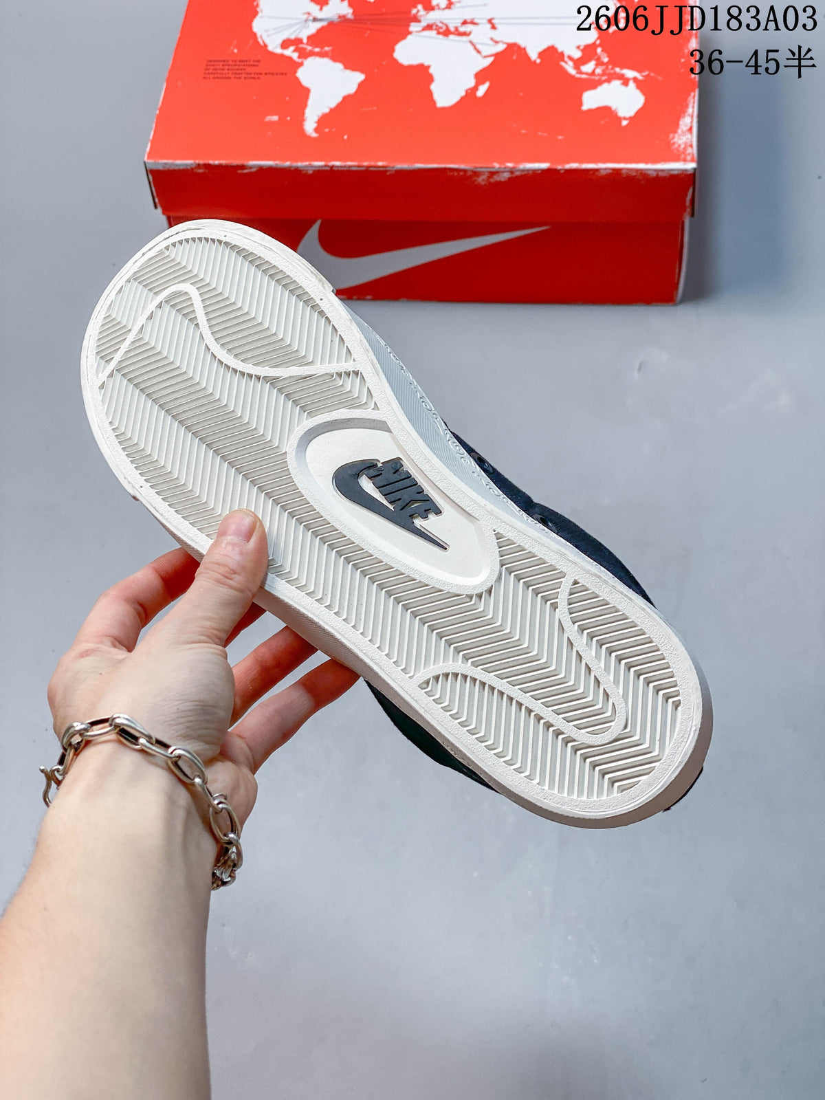 Close-up of the white sneaker outsole with herringbone tread and Nike branding