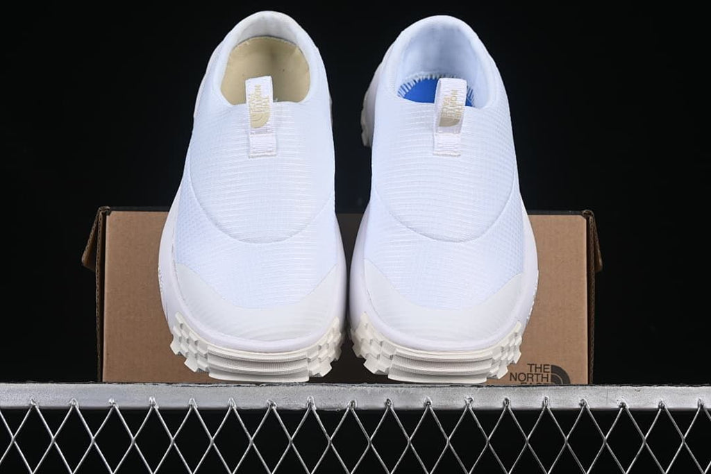 Front view of the pair of white slip-on mule sneakers