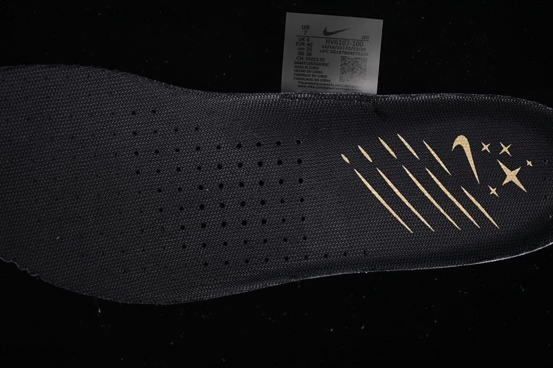 Dark insole with gold-colored graphic and shoe size label visible behind it