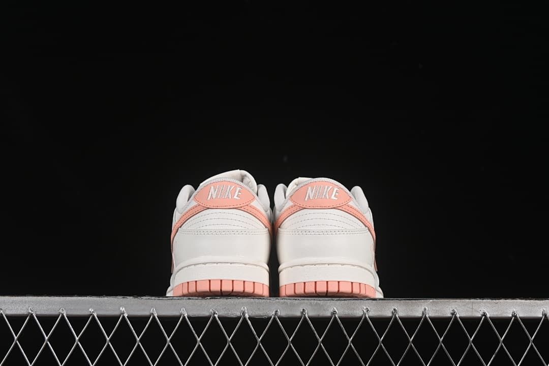 Rear view of both shoes with pink heel accents